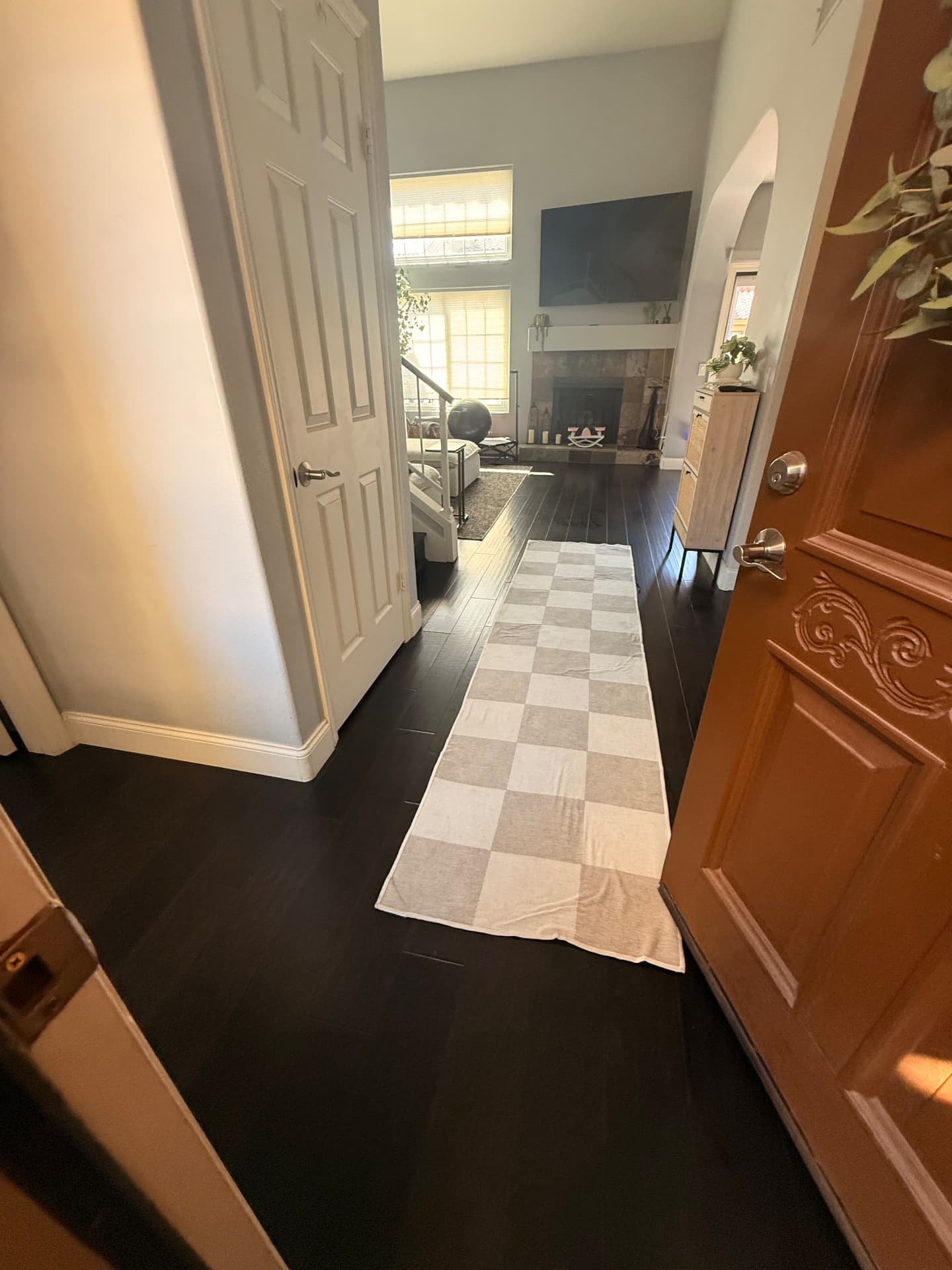 Entry hallway with mopped dark hardwood leading to the living room after a Lustre Haus clean in Scottsdale